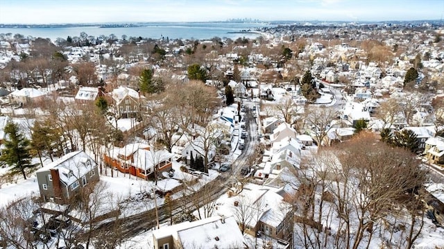 snowy aerial view with a water view