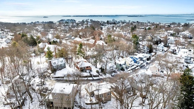 snowy aerial view featuring a water view