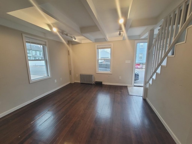 interior space with beamed ceiling, radiator heating unit, and dark wood-type flooring