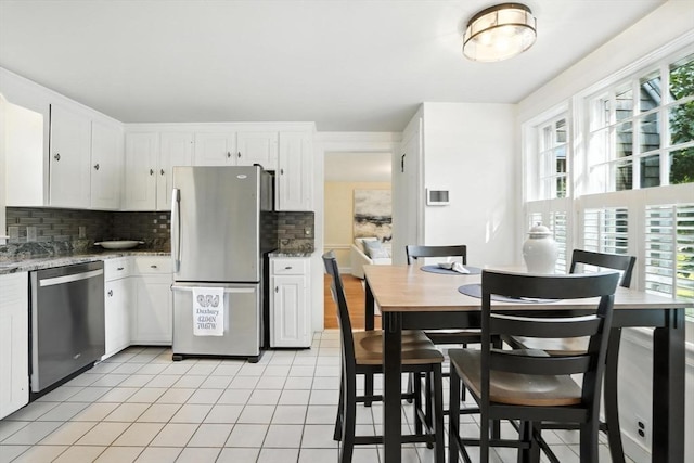 14 Wadsworth Ln, Duxbury, MA 02332 - kitchen featuring stainless steel appliances, decorative backsplash, light tile patterned floors, white cabinetry, and light stone countertops
