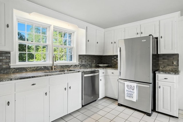 14 Wadsworth Ln, Duxbury, MA 02332 - kitchen featuring stainless steel appliances, backsplash, white cabinetry, light tile patterned floors, and dark stone counters