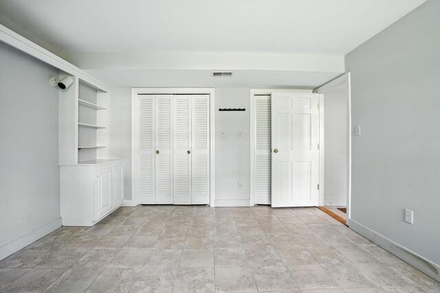 14 Wadsworth Ln, Duxbury, MA 02332 - unfurnished bedroom with multiple closets and stone finish floors