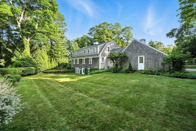 14 Wadsworth Ln, Duxbury, MA 02332 - rear view of house with a lawn and a chimney