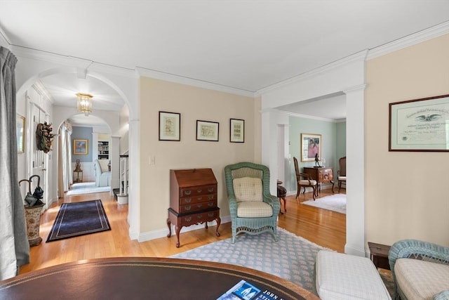 151 River Rd, West Newbury, MA 01985 - living area featuring wood finished floors, decorative columns, arched walkways, crown molding, and baseboards