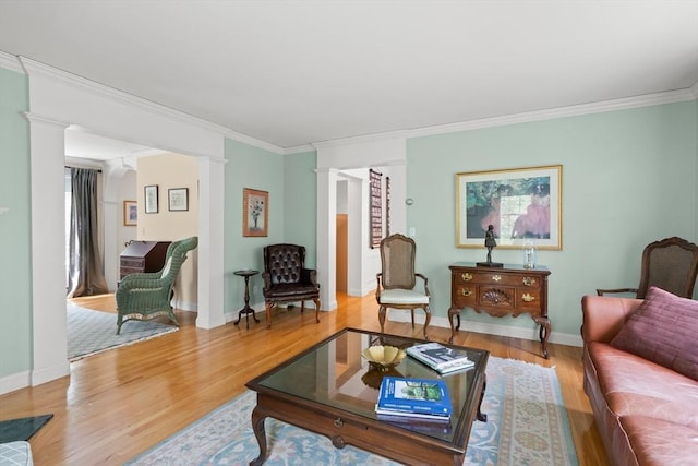 151 River Rd, West Newbury, MA 01985 - living area with decorative columns, crown molding, wood finished floors, and baseboards