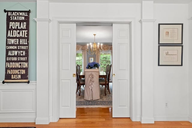 151 River Rd, West Newbury, MA 01985 - entryway featuring a chandelier, light wood-type flooring, and wainscoting