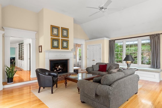 151 River Rd, West Newbury, MA 01985 - living room with a fireplace, light wood-type flooring, ceiling fan, decorative columns, and vaulted ceiling