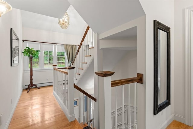 151 River Rd, West Newbury, MA 01985 - hall with a baseboard heating unit, light wood-type flooring, a chandelier, and baseboards