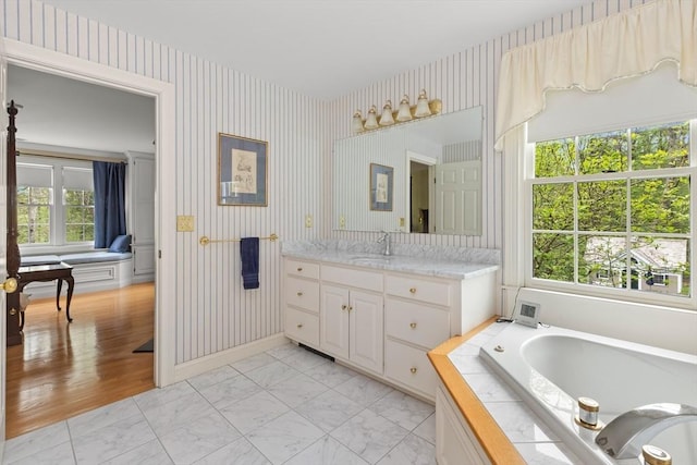 151 River Rd, West Newbury, MA 01985 - bathroom featuring wallpapered walls, plenty of natural light, vanity, a garden tub, and marble look tile flooring