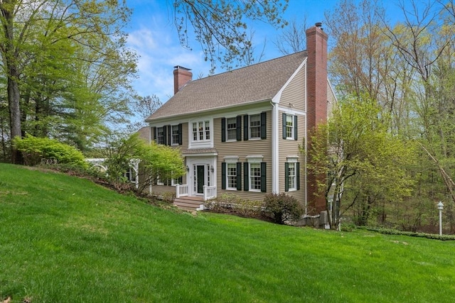 151 River Rd, West Newbury, MA 01985 - view of front of house featuring a chimney, a front lawn, and a shingled roof
