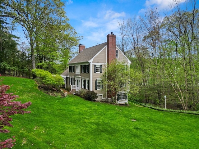 151 River Rd, West Newbury, MA 01985 - rear view of house featuring a chimney and a lawn