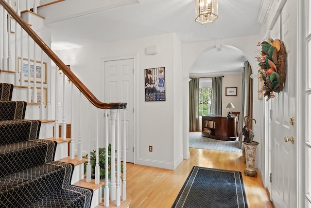 151 River Rd, West Newbury, MA 01985 - foyer with arched walkways, light wood finished floors, stairs, and baseboards