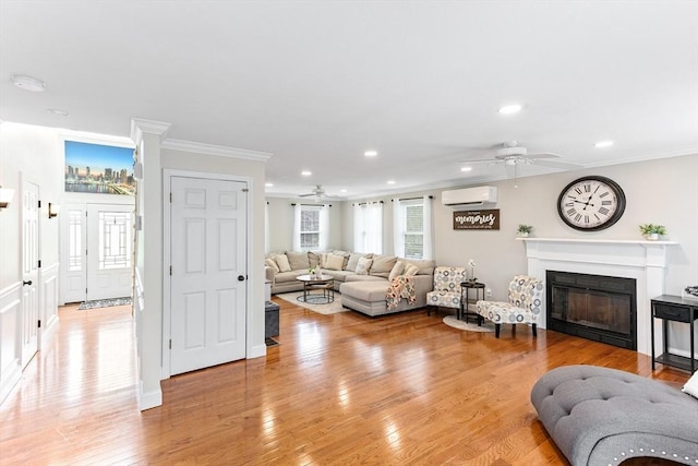1380 Newman Ave, Seekonk, MA 02771 - living area with ceiling fan, a wall mounted AC, a glass covered fireplace, crown molding, and light wood finished floors