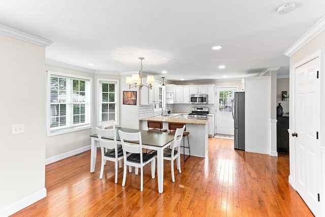 1380 Newman Ave, Seekonk, MA 02771 - dining room featuring a chandelier, light wood-style flooring, ornamental molding, baseboards, and recessed lighting