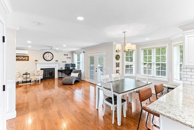 1380 Newman Ave, Seekonk, MA 02771 - dining space featuring ornamental molding, an AC wall unit, a glass covered fireplace, ceiling fan, and light wood-style flooring