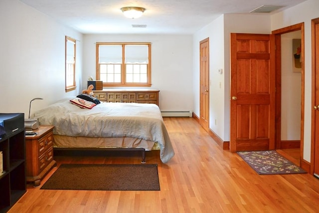 110 Mayflower Ridge Dr, Wareham, MA 02571 - bedroom with a baseboard heating unit, light wood-style floors, and baseboards