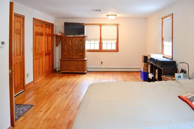 110 Mayflower Ridge Dr, Wareham, MA 02571 - bedroom featuring a baseboard radiator, light wood finished floors, and baseboards