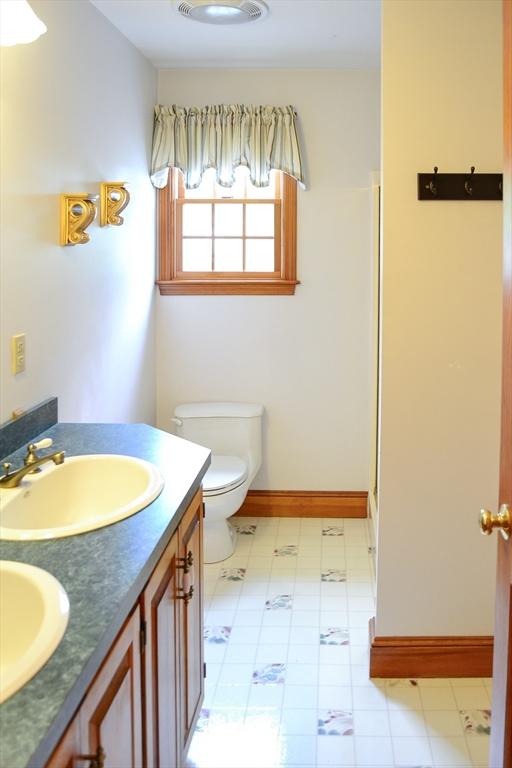 110 Mayflower Ridge Dr, Wareham, MA 02571 - bathroom with toilet, double vanity, baseboards, and tile patterned floors