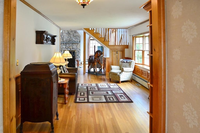 110 Mayflower Ridge Dr, Wareham, MA 02571 - sitting room with wood finished floors, a fireplace, a baseboard heating unit, a baseboard radiator, and stairs