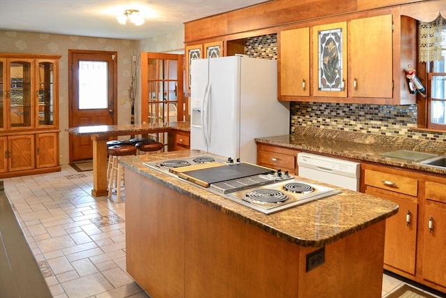 110 Mayflower Ridge Dr, Wareham, MA 02571 - kitchen with white appliances, a center island, tasteful backsplash, and brown cabinetry