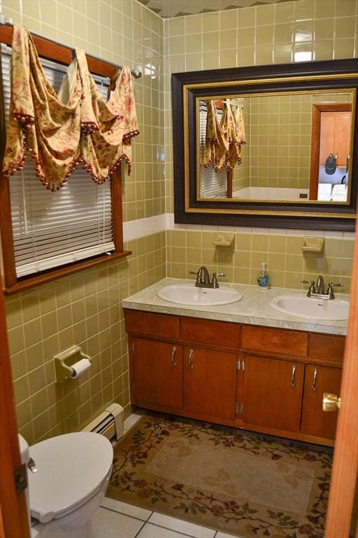 110 Mayflower Ridge Dr, Wareham, MA 02571 - bathroom featuring tile walls, double vanity, toilet, a baseboard heating unit, and tile patterned floors