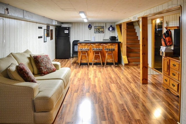 110 Mayflower Ridge Dr, Wareham, MA 02571 - living area with a bar, light wood-style flooring, stairway, and wooden walls