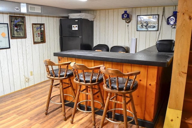 110 Mayflower Ridge Dr, Wareham, MA 02571 - indoor dry bar with freestanding refrigerator, wood walls, and wood finished floors