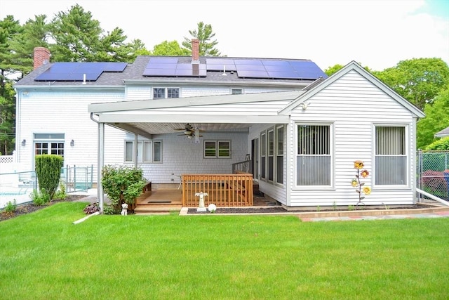 110 Mayflower Ridge Dr, Wareham, MA 02571 - rear view of property with a ceiling fan, a chimney, roof mounted solar panels, and a deck