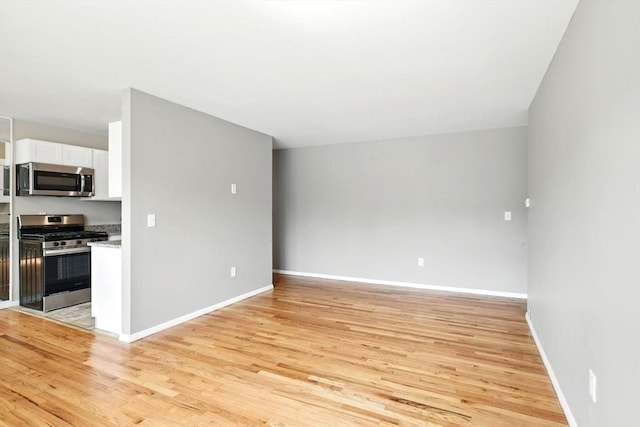 interior space featuring baseboards and light wood-type flooring