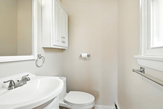 half bathroom with a sink and toilet