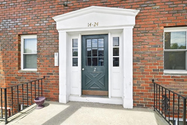 view of exterior entry with brick siding