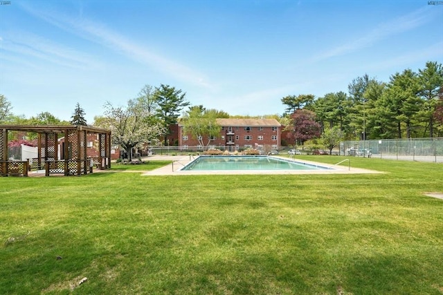view of yard with fence and a community pool