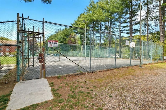view of sport court featuring a gate, fence, and community basketball court