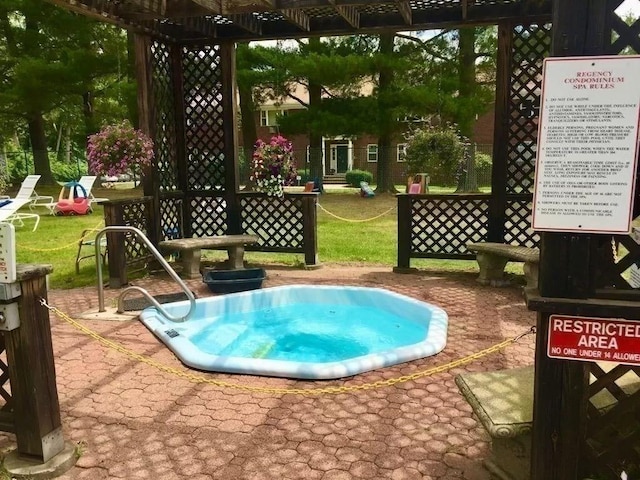 view of swimming pool featuring a pergola, a yard, and a patio