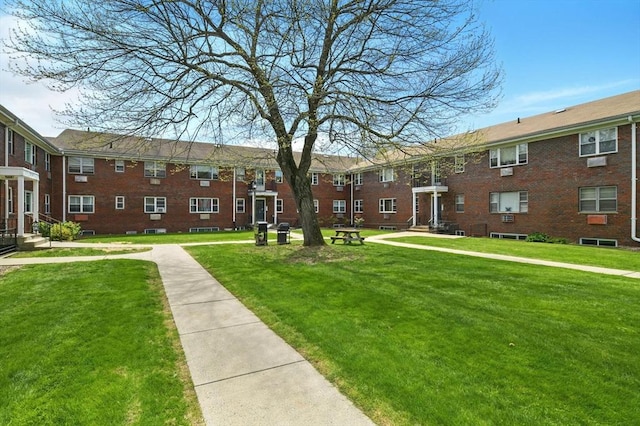view of home's community with a yard