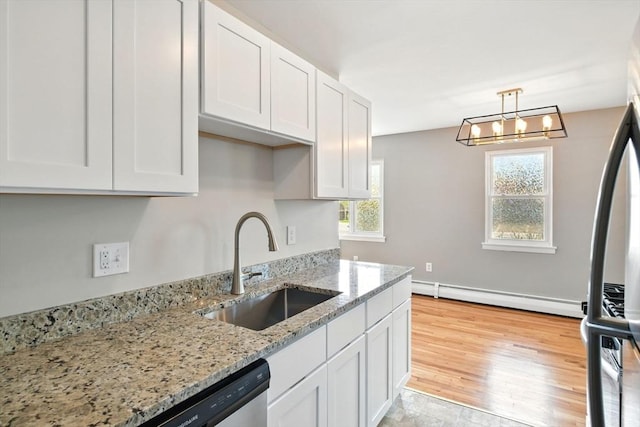 kitchen featuring white cabinetry, a baseboard heating unit, a sink, and light wood-style flooring