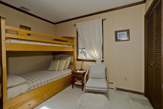 bedroom featuring visible vents, a baseboard heating unit, baseboards, and ornamental molding