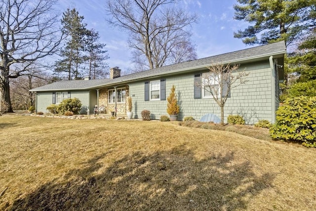 single story home featuring a front lawn and a chimney