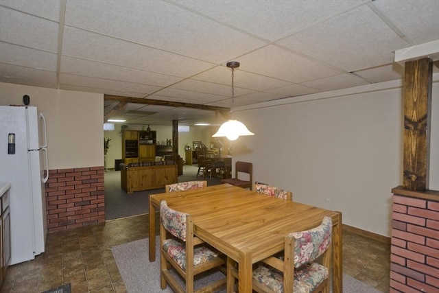 dining area featuring a paneled ceiling