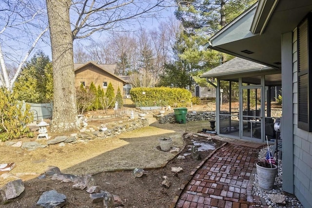 view of yard featuring a patio and a sunroom