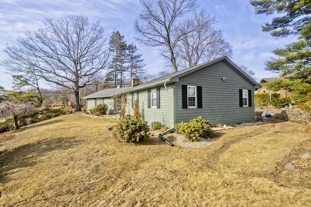 view of home's exterior with a lawn and a garage