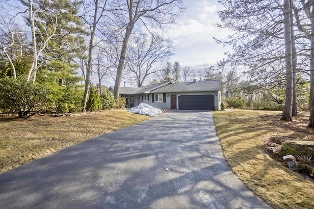 single story home with driveway and a garage