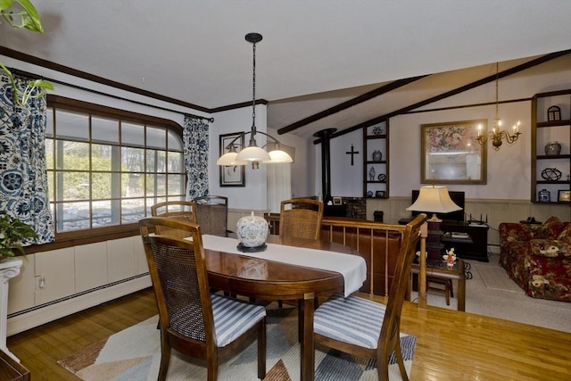 dining space with baseboard heating, vaulted ceiling with beams, wood finished floors, and a wainscoted wall