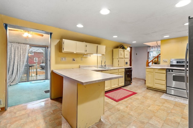 kitchen featuring stainless steel range, sink, kitchen peninsula, light colored carpet, and a breakfast bar