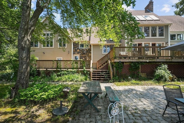 94 S Shore Rd, Burrillville, RI 02859 - rear view of property with a deck, a patio area, a chimney, stairs, and a shingled roof