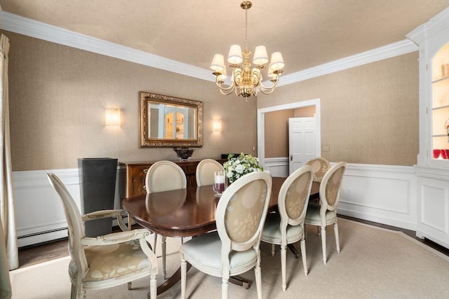 dining area featuring a chandelier, a baseboard radiator, a wainscoted wall, wood finished floors, and crown molding