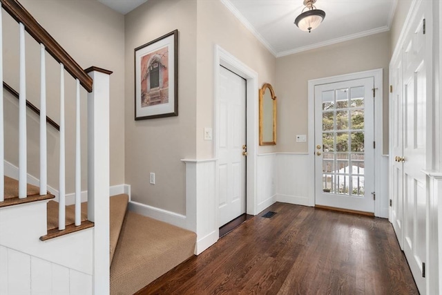 entrance foyer with dark wood-type flooring, visible vents, baseboards, stairway, and crown molding