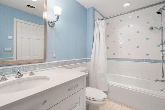 bathroom with visible vents, toilet, shower / bath combo with shower curtain, vanity, and tile patterned floors