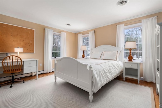 bedroom with multiple windows, visible vents, and crown molding