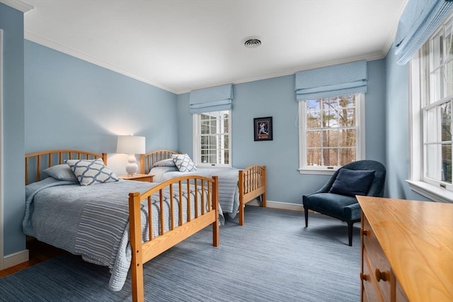 bedroom featuring visible vents, crown molding, and baseboards